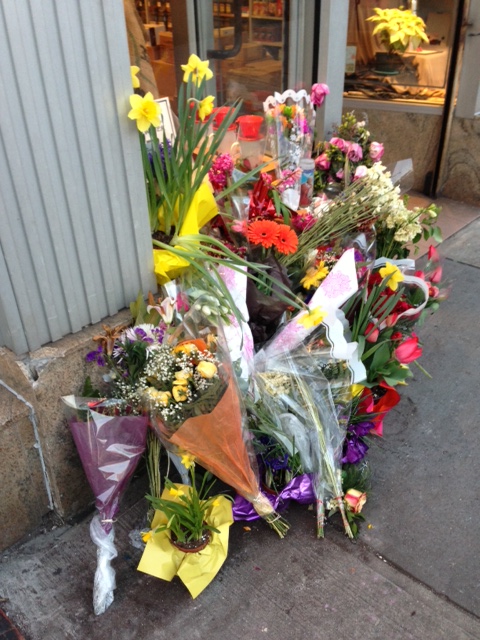 People left cut flowers and potted plants in the spot where Martha Atwater was killed by an out of control driver.