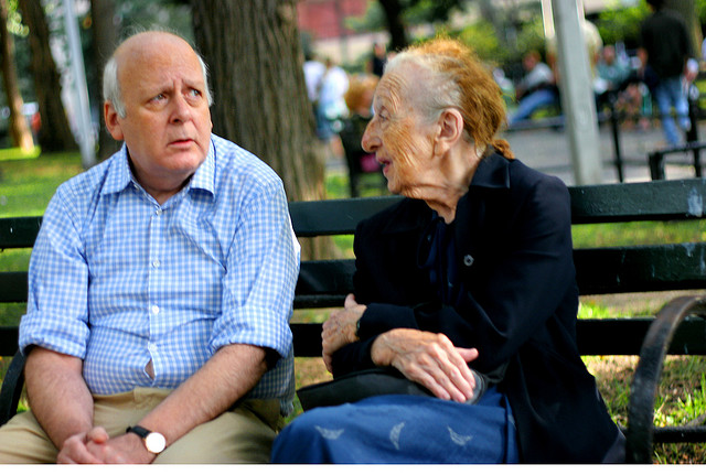 couple talking on a park bench