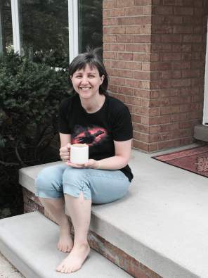 Alex Kourvo in front of her new, smaller house.